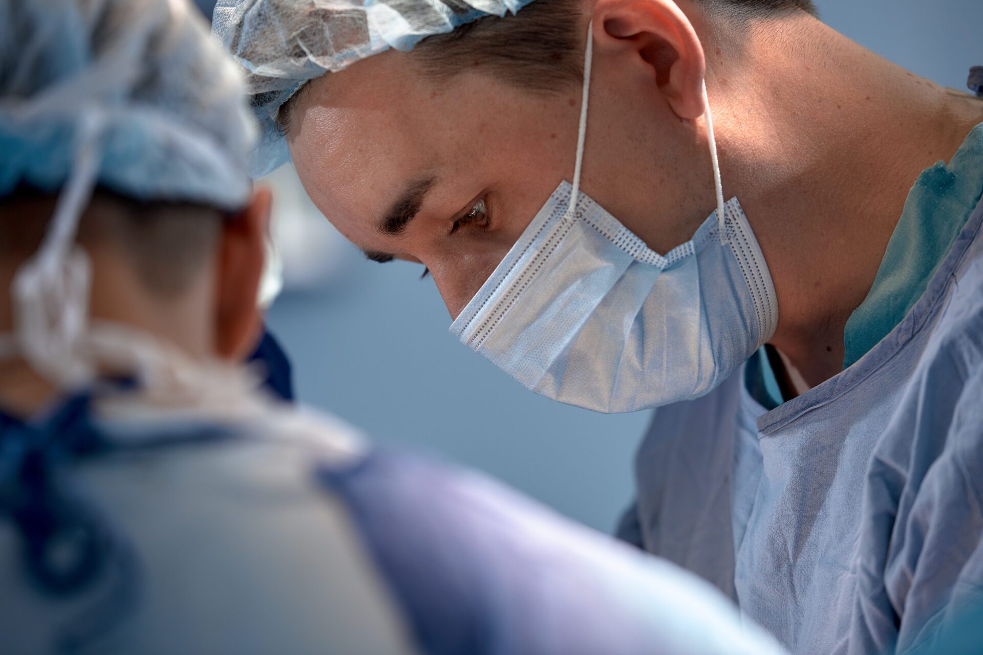 faces of surgeons in the operating room during the operation. Modern medicine, medical workers during a complex operation, modern medicine Volunteer giving a box with donations to another volunteer